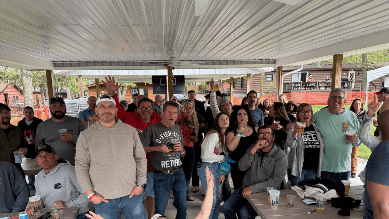 2 A large crowd posing for a picture out of the sun at Spring Fling at the Island Club pavilion.